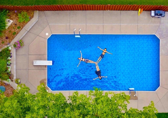 Aerial view of 3 women doing synchronized swimming