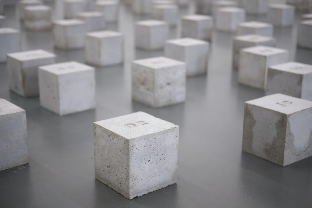 Blocks of white concrete on a shiny black surface