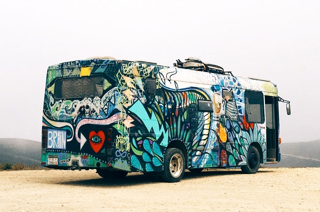 Image of a bus painted with a multi-colored design