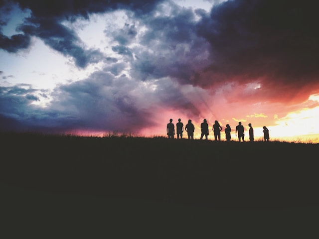 Image of a sunset and silhouettes of people